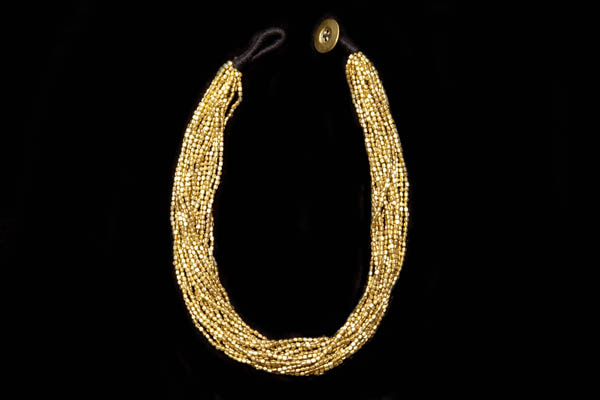A Necklace Of Seventeen Strands Of Small Rectangular Brass Beads