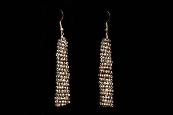 A Pair Of Drop Earrings, Each Decorated With A Coiled Tubular Bands Of Small Round Dark Metallic Grey Resin Beads