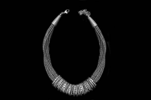 A Silvered Metal Twenty-Two Strands Of Small Beads Necklace With Fifteen Rings Of Facetted Beads