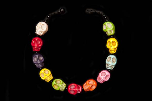 A Necklace Of Eleven Large Multicoloured Dyed Howlite Skull Beads With Black Onyx Round Spacers