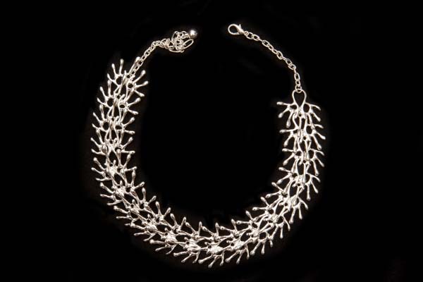 A Necklace Of NineteenLinked Silvered Metal Fan Shaped Branches Beads On A Silvered Metal Chain