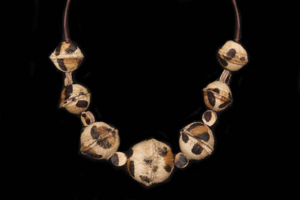 A Necklace Of Seven Fur Covered Dyed 'Leopard Skin' Round Ridged Beads With Fur Disc Spacers