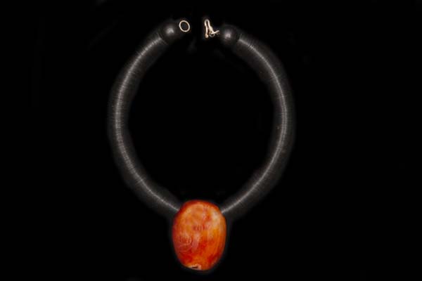 A Madagascar Cornelian Large Oval Pendant Suspended From A Bakelite Circular Discs Necklace