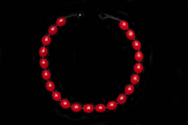 A Necklace Of Twenty-One Early Dutch Red Glass Oval Trade Beads With Black Onyx Small Round Spacers