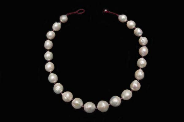 A Necklace Of Twenty-Two Very Large Round White Freshwater Pearls With Small Round Garnet Spacers