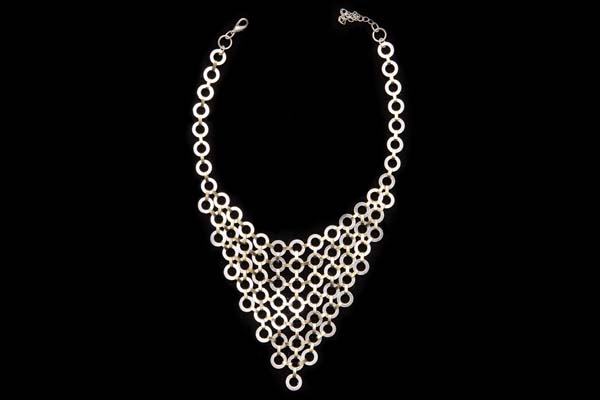 A Triangular Shaped Necklace Of Silvered Metal Flat Rings Linked With Golden Metal Bars