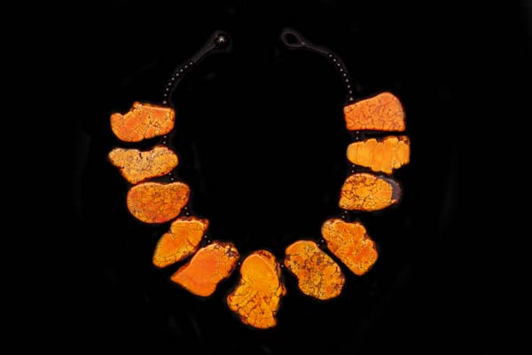 A Necklace Of Eleven Orange Dyed Magnesite Irregular Shaped Sliced Graduated Sliced Drops With Black Onyx Round Spacers