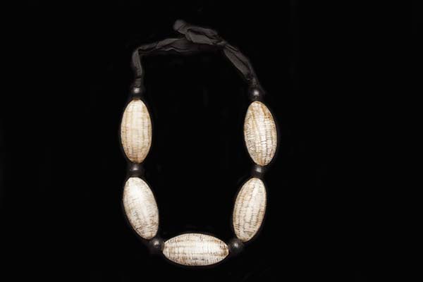 A Necklace Of Five Large Beige Buffalo Horn Carved Pointed Oval Beads With Black Wood Round Spacers