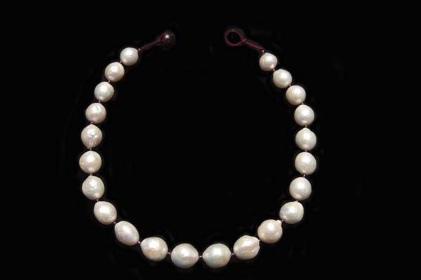 A Necklace Of Twenty-Two Large White Freshwater Pearls With Garnet Small Round Spacers.