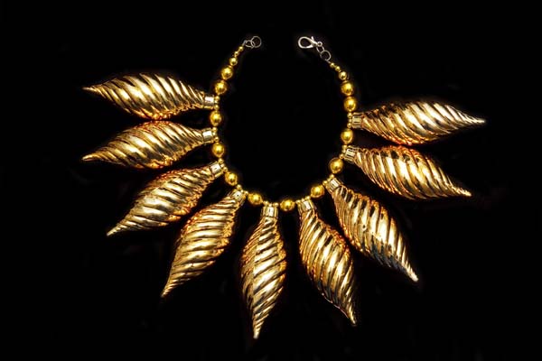 A Large Necklace Of Nine Golden Coated Plastic Pine Cone Shaped Spiral Patterned Hollow Drops