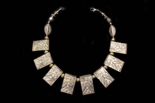 A Silvered Metal Necklace Of Flower Patterned Rectangular Drops And Silvered Metal Fluted Spacers
