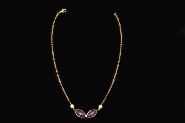 A Gold Plated Chain Necklace With Two Amethyst Domed Pointed Oval Cabochons In Gold Plated Frames