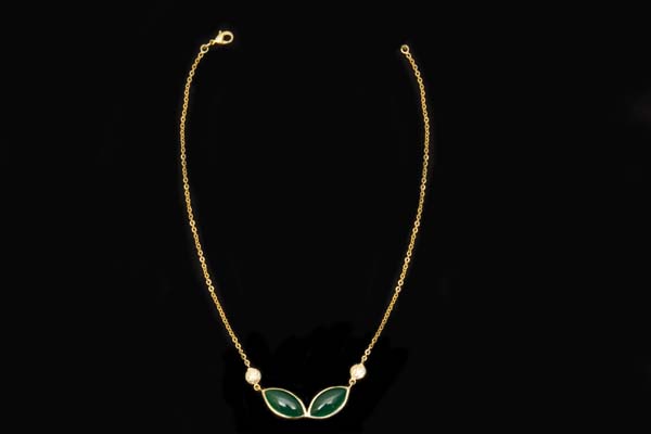 A Gold Plated Chain Links Necklace With Two Green Onyx Domed Oval Cabochons In Gold Plated Frames