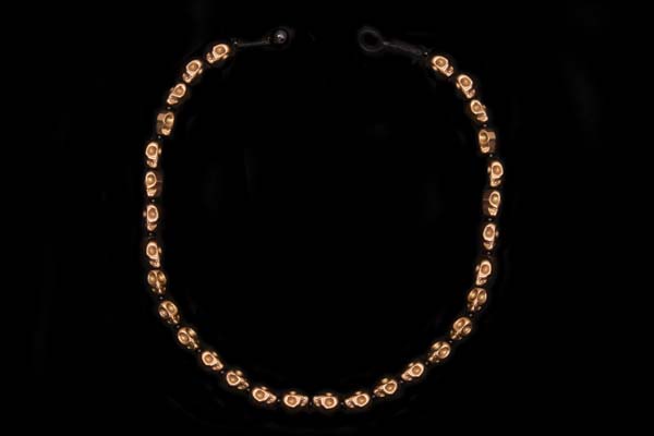 A Necklace Of Thirty-Two Coppered Metal Small Skull Beads With Black Onyx Small Round Spacers