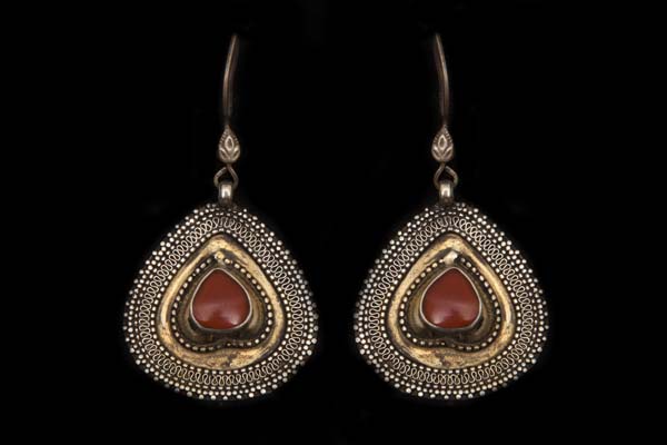 A Pair Of Afghan Silvered And Golden Metal Patterned Teardrop Earrings With Brown Glass Cabochon Centres