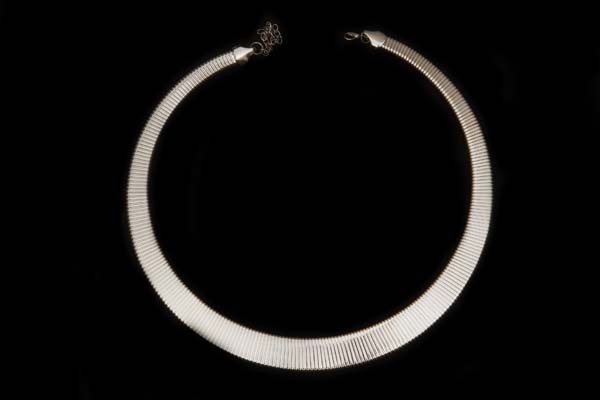 A Silvered Metal Flat Circular Necklace Made Up From Interlocking Rectangular Tapered bands