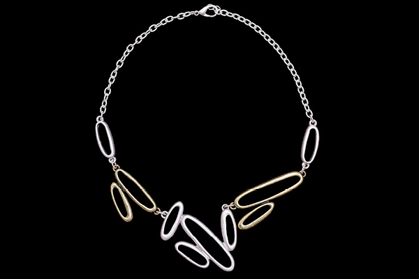A Silvered Metal Chain Necklace With Six Silvered  And Four Golden Metal Mixed Sized Oval Bands