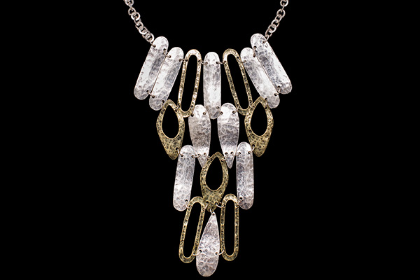 A Silvered Metal Chain Necklace With Linked Silvered Metal Panels And Golden Metal Panels Loops