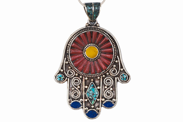 A Nepalese Patterned Silver Plated 'Hand' Pendant Necklace Inlaid With Red, Blue, And Yellow Glass