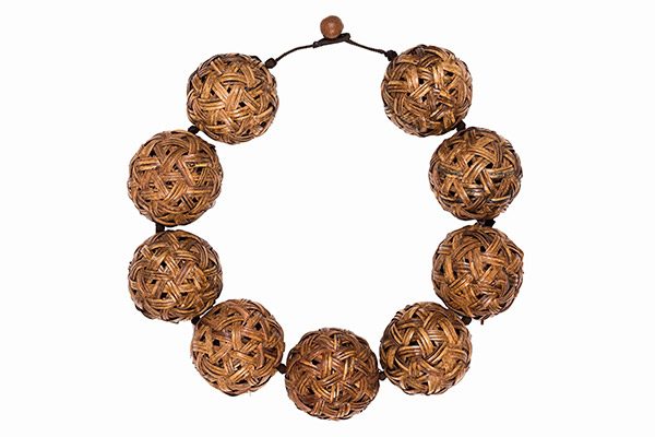 A Thai Necklace Of Nine Large Round Hollow Beads Of Interlocking Woven Brown Cane Bands