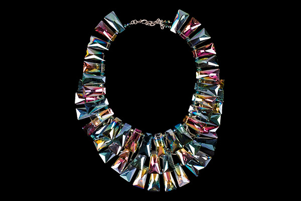 A Large Three Strand Necklace Of Dark Multicoloured Iridescent Facetted Keystone Shaped Glass Beads