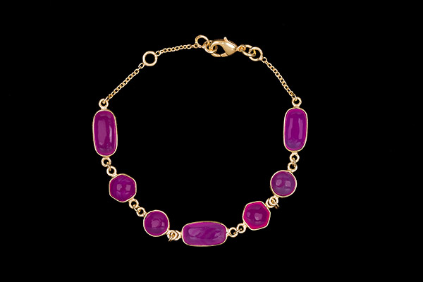 A Gold Plated Chain Links Bracelet Decorated With Seven Fuchsia Dyed Agate Domed Cabochons