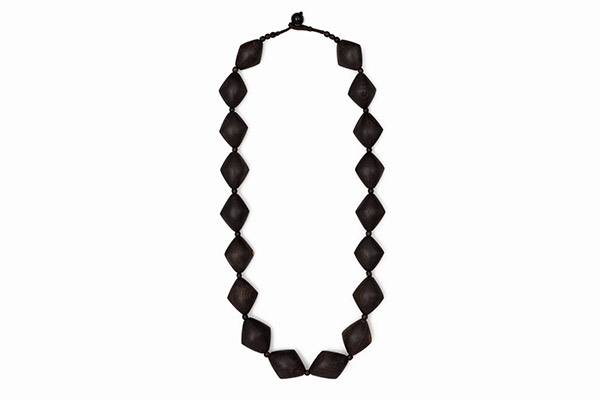 A long Necklace Of Eighteen Dark Brown Wood Domed Diamond Shaped Beads With Round Spacers