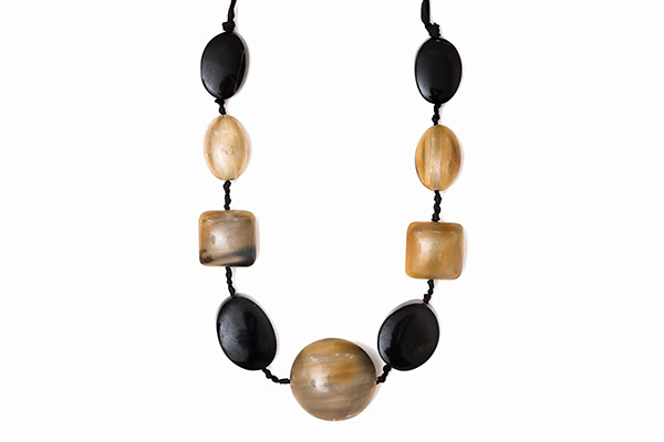 A Black Cloth Long Necklace With Cream And Black Buffalo Horn Domed Oval, Square, And Circular Beads