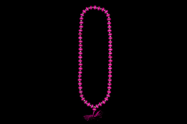 A Long Necklace Of Sixty Fuchsia Dyed Resin Button Beads With Silvered Metal Patterned Disc Spacers