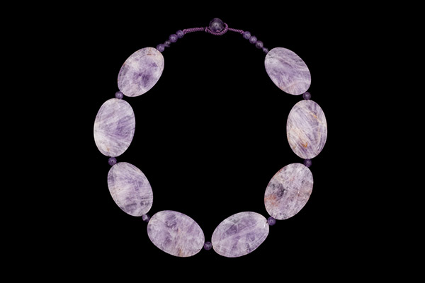A Necklace Of Eight Brazilian Patterned Amethyst Domed Oval Beads With Amethyst Round Spacers