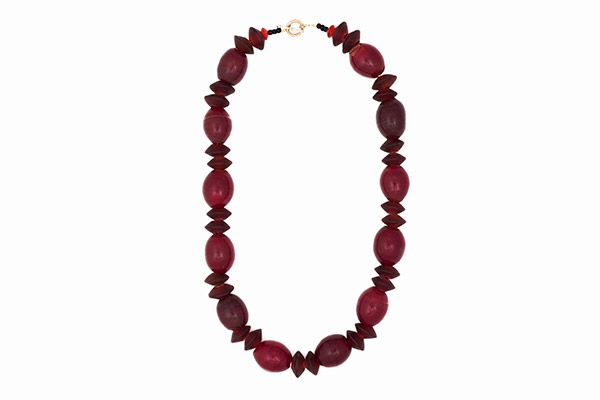 A Long Necklace Of Twelve Dutch Dark Red Glass Oval Beads And Small Bohemian Red Glass Saucer Beads