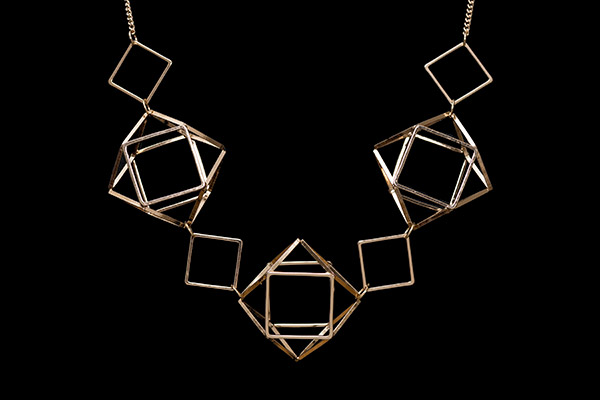 A Gold Plated Necklace With Three Cuboctahedron Shaped Banded 'Cages' And Diamond Shaped Band Beads