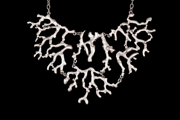A Silvered Metal Chain Links Pendant Necklace With Three Linked Panels Of Stylised Branches