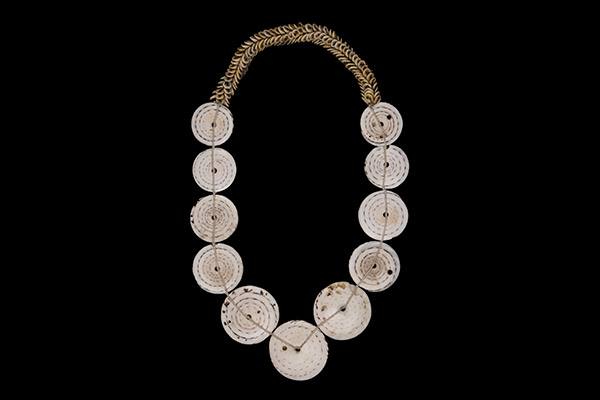 A New Guinea Necklace With Eleven White Circular Shell Discs On A Band Of Small Cream Cowrie Shells