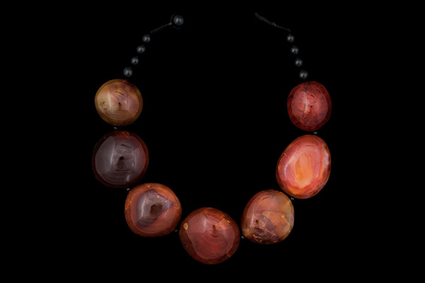 A Necklace Of Seven Madagascar Cornelian Large Domed Oval Tumbles With Black Onyx Round Beads