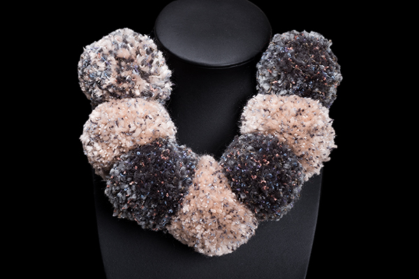 A Necklace Of Seven Very Large Brown, Beige, And Grey Wool Pompoms And Black Onyx Small Round Beads