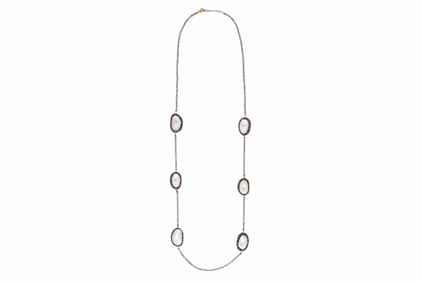 A Long Necklace Of Small Hematite Facetted Round Beads And Six Large Domed Oval White Shell Beads