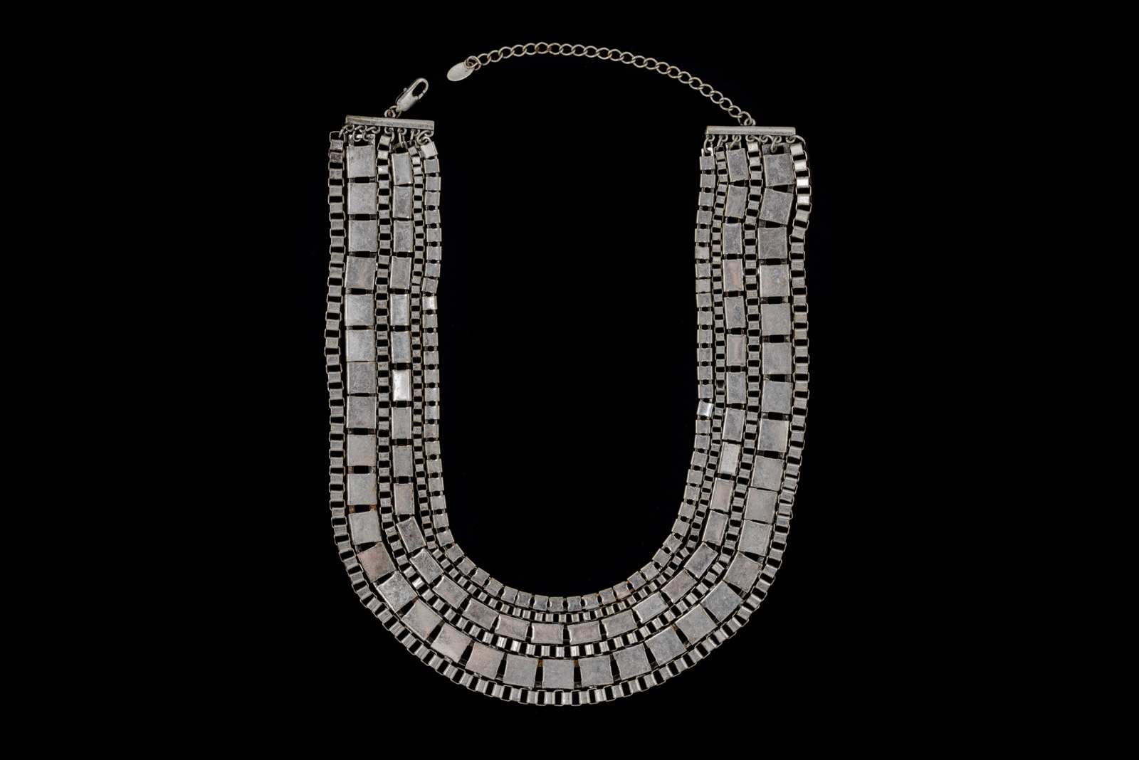 A Silvered Metal Six Band Necklace Of Rectangular And Square Beads.