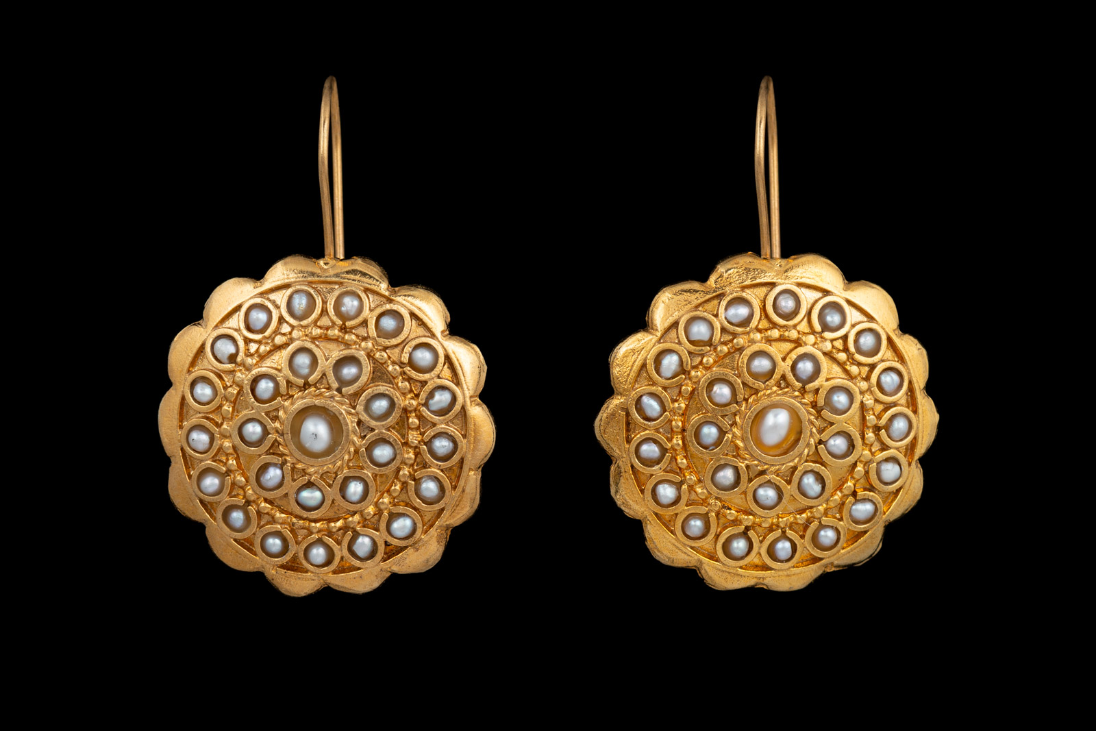 A Pair Of Gold Plated Circular Earrings With A Border Of Small Curved Panels, A White Freshwater Pearl Centre, And Two Circular Bands Inlaid With Small White Freshwater Pearls.