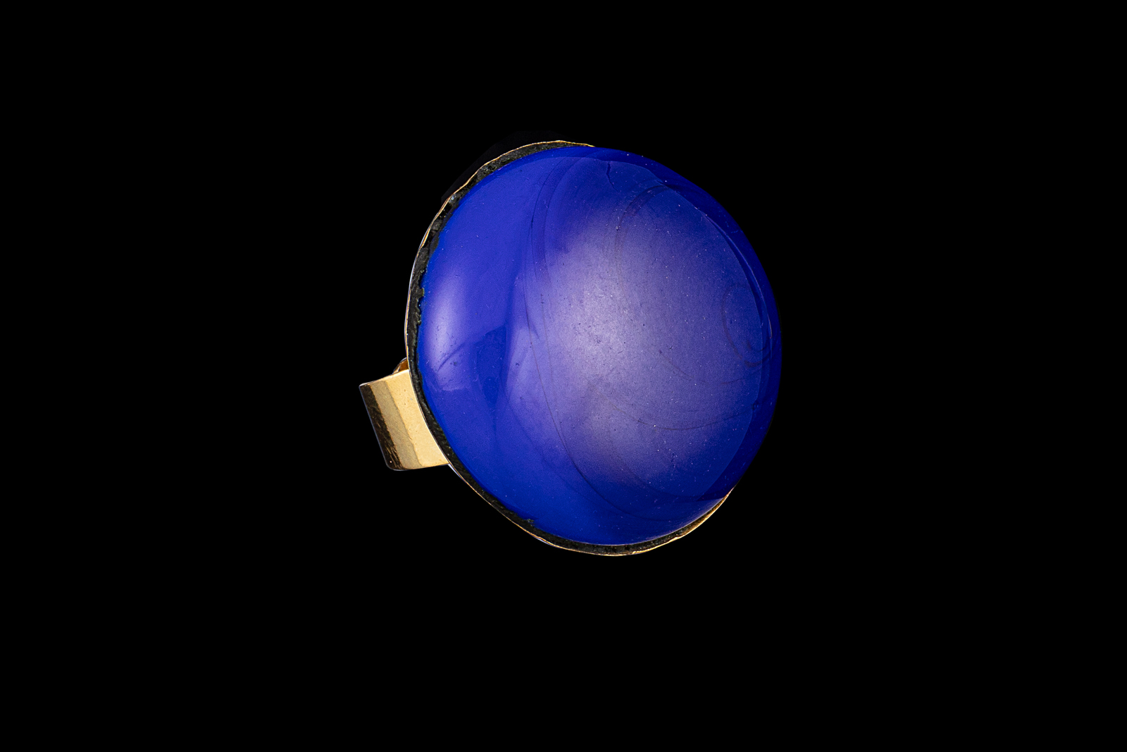 A Brass Adjustable Band Ring With A Circular Bezel Inlaid With A Blue Resin Domed Disc.