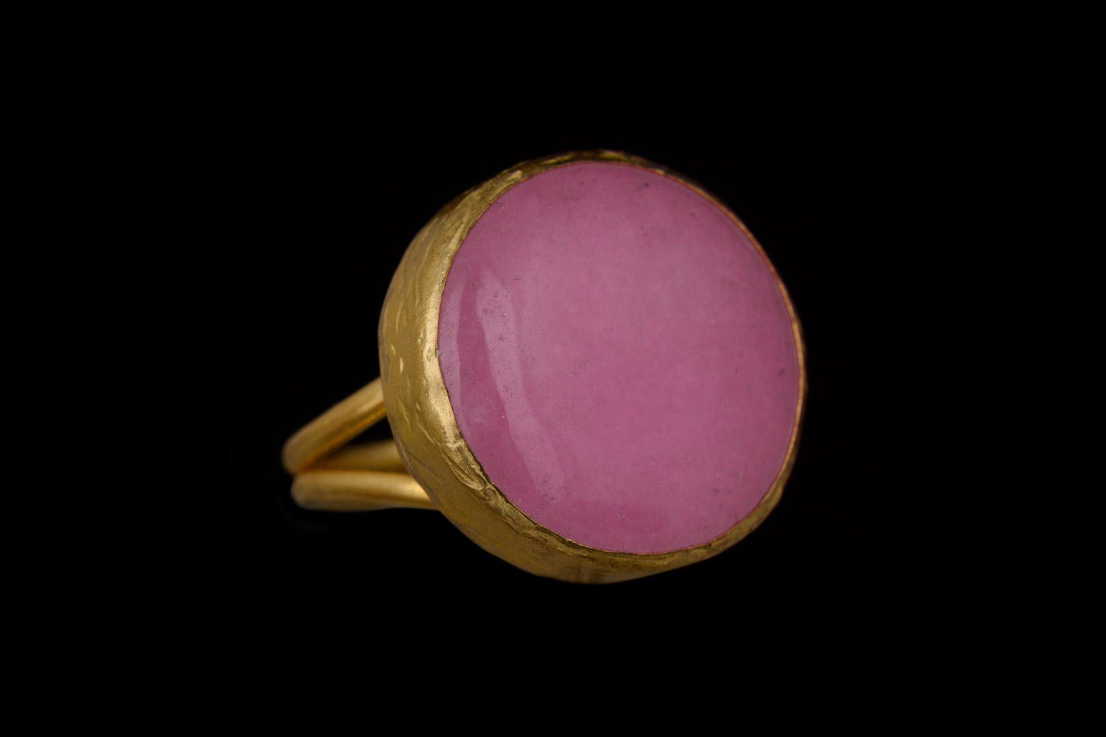 A Gold Plated Adjustable Double Band Ring With A Circular Bezel Inlaid With A Pink Dyed Agate Domed Circular Cabochon.
