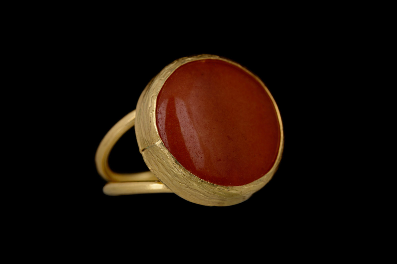 A Gold Plated Adjustable Double Band Ring With A Circular Bezel Inlaid With An Orange Dyed Agate Domed Circular Cabochon.