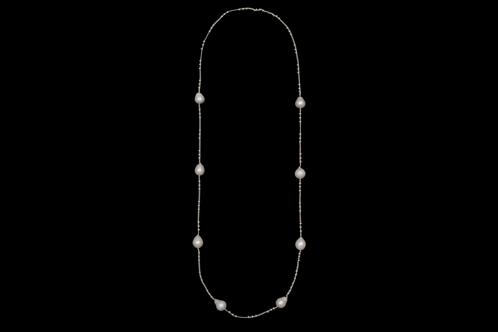 A Long Silver Plated Chain Necklace, Decorated With Very Small Round Silver Plated Beads And Eight Oval White Freshwater Pearls.