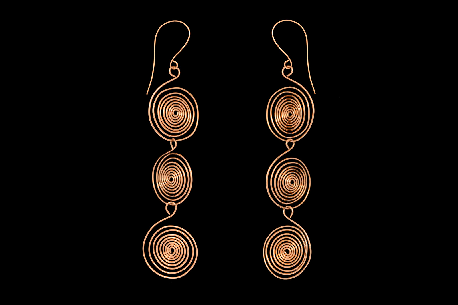 A Pair Of Long Drop Earrings With Three Linked Circular Coiled Brass Bands.