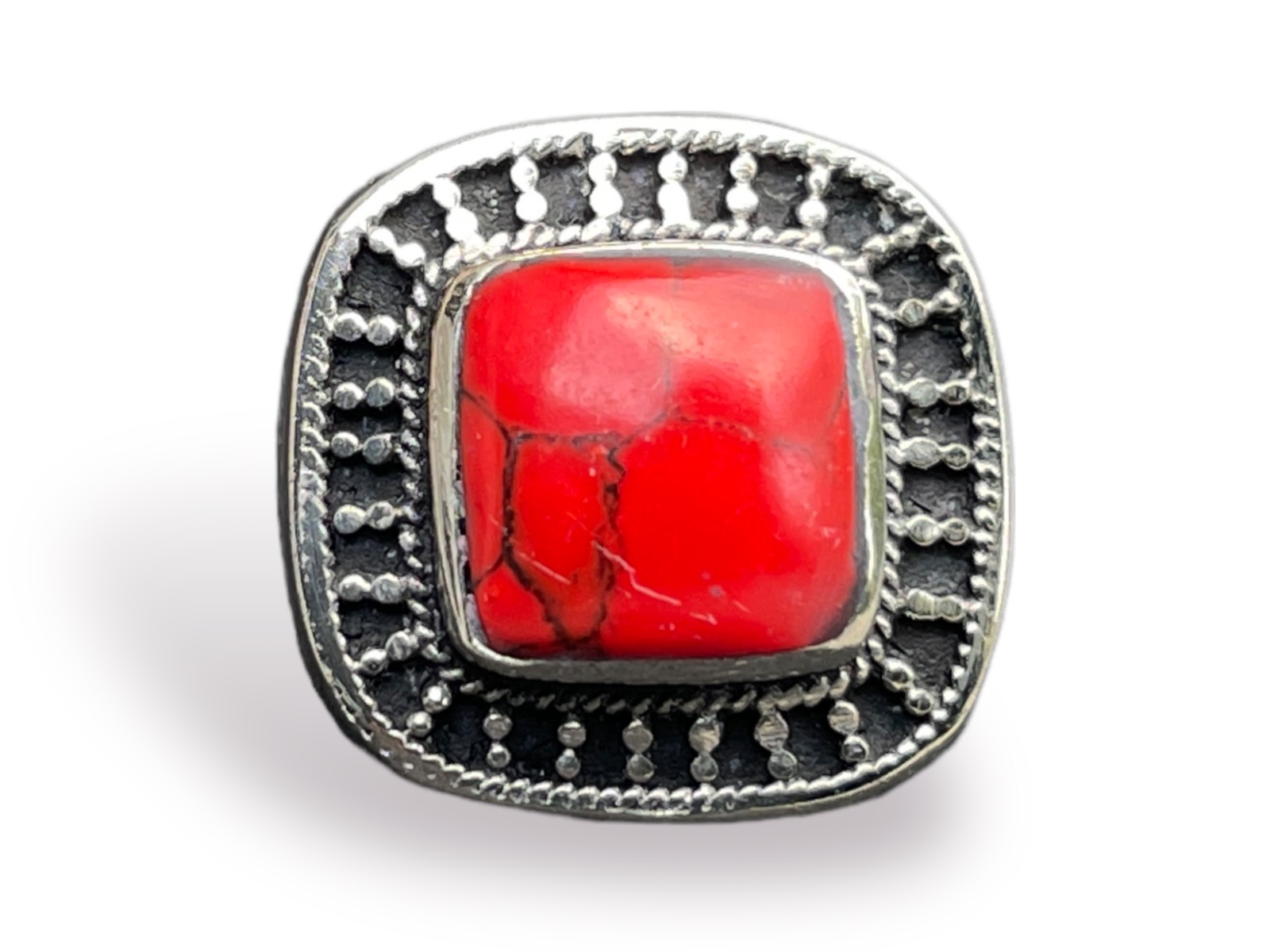 An Afghan Silvered Metal Square Patterned Ring Inlaid With A Red Dyed Howlite Cabochon