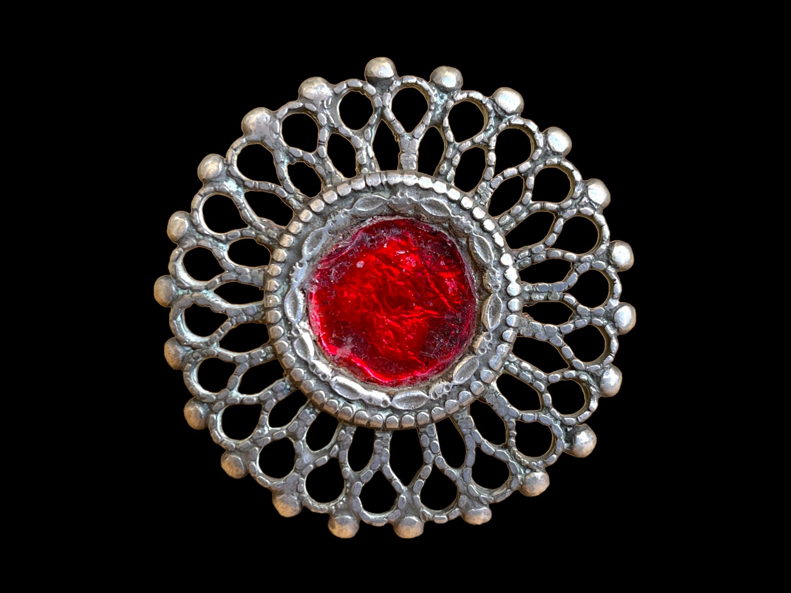 An Afghan Old Traditional Large Silver Ring With A Circular, Floral Patterned Filigree Top, Inlaid With A Red Glass Circular Centre.