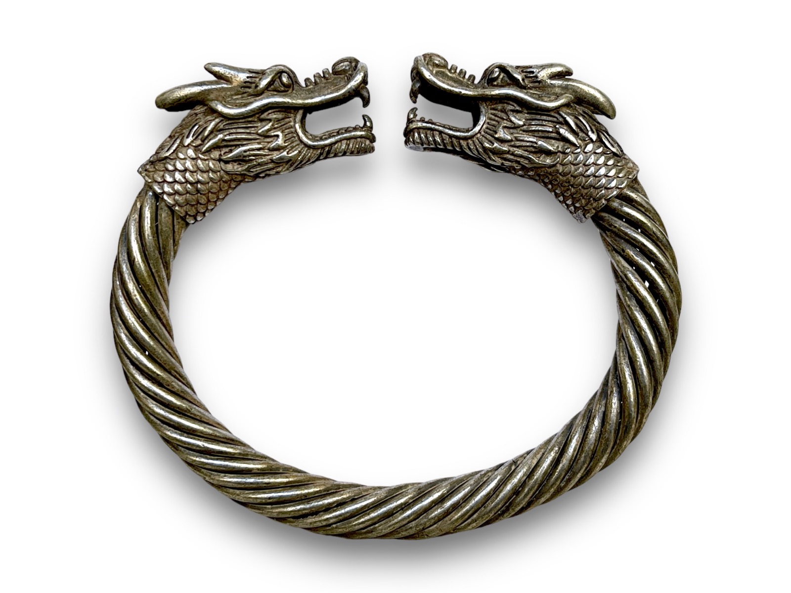 A Miao Old Silver Plated Coiled Bands Open Cuff, With Two Dragon Head Finials. China.