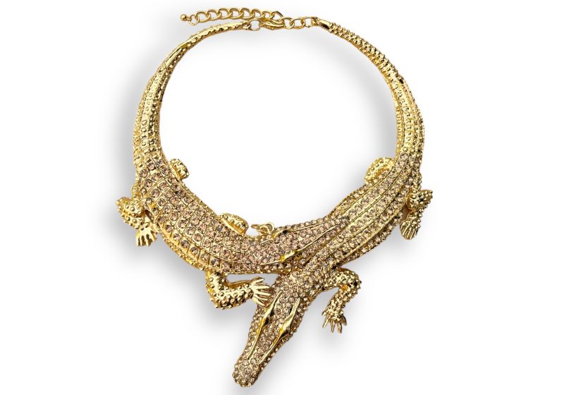 A Golden Metal Circular Tapered Band Necklace Of Two Crocodiles, Each Inlaid With Small Golden Facetted Glass Beads.