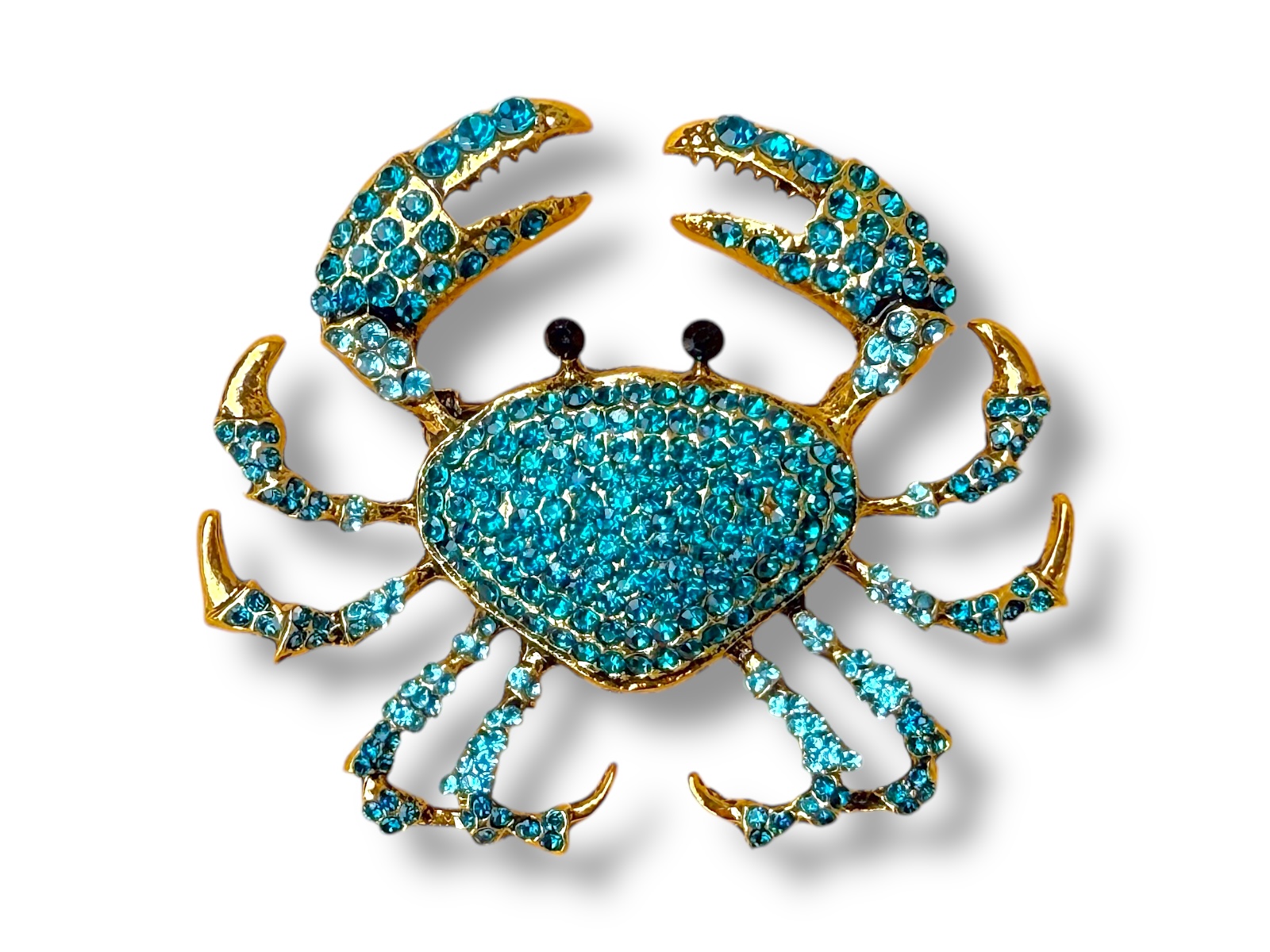 A Golden Metal Brooch Of A Crab, Inlaid With Small Turquoise Facetted Glass Cabochons, And Two Small Black Facetted Glass Eyes.