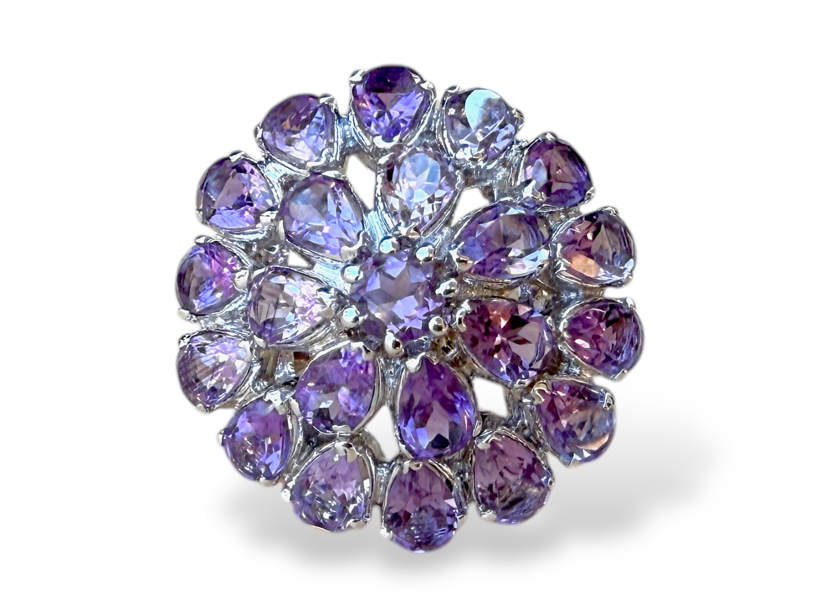 A Silver Ring With A Domed Circular Top, Inlaid With Amethyst Small Facetted Teardrop Beads And One Facetted Circular Bead.